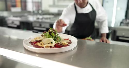 Restaurant, pass and chef with meal, hands and food order ready in kitchen