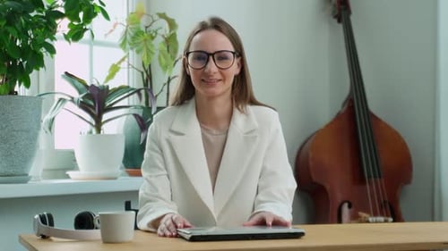 Woman Smiling at Desk with Laptop