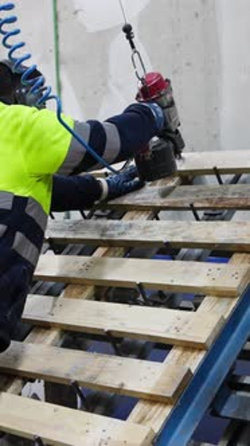 Carpenter Assembling Wooden Pallets in Slow Motion