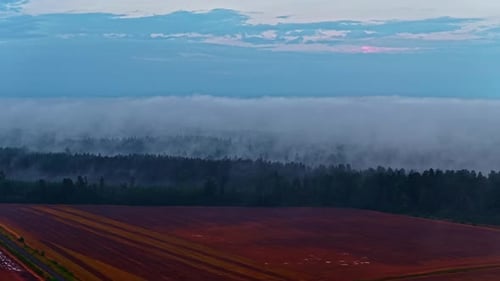 Sunset over glowing farmland, wide aerial