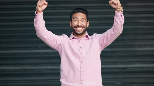 Young Man Celebrating Success with Joyful Expressions
