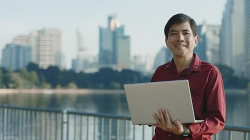 Adult Using Laptop in City Park Environment