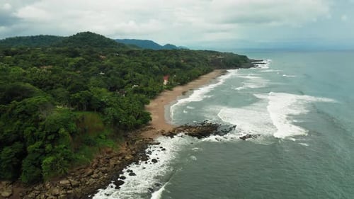 4K Aerial Drone shot of Tambor Empty Beach in Costa Rica.
Dramatic Weather with Red Sand and Waves S