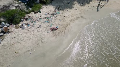 Aerial view gentle sea wave move toward plastic rubbish