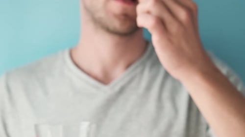 Adult Taking Pill and Drinking Water Close Up
