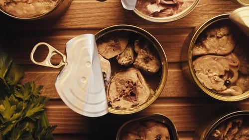 Opening Metal Cans with Canned Fish and Pate on Table Top View Canned Salmon and Tuna Macro Canning
