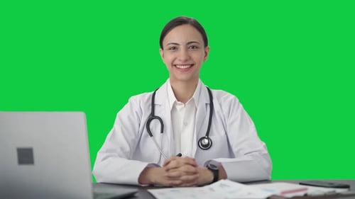 Happy Indian female doctor wearing stethoscope Green screen