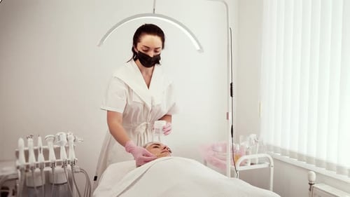 Cosmetologist Beautician Applying Anti Aging Cream During Procedure at Cosmetology Clinic Female