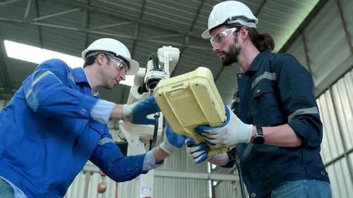 Engineers Testing Robotics Technology in a Factory Setting