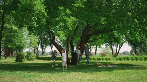 Family Togetherness and Playtime Under a Shady Tree