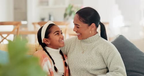 Mother and Daughter Laughing Together Indoors