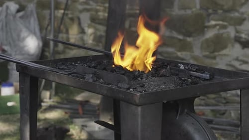 Close-up of a blacksmith’s forge with flames and coals
