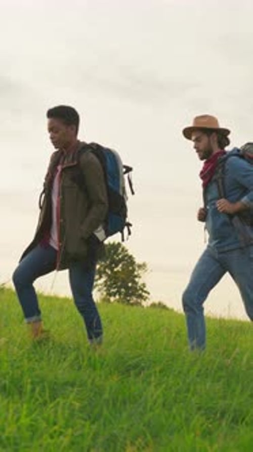 Hikers on a Beautiful Grassy Hillside
