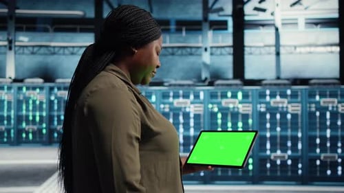 Admin in Server Facility Using Chroma Key Tablet to Deploy New Server Architecture