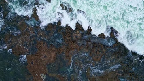 Swirling Water Foaming Coast Cliffs Zoom Out. Top Drone View Rough Sea