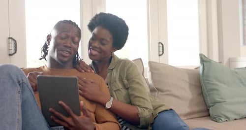 Couple Relaxing and Using Tablet on Couch
