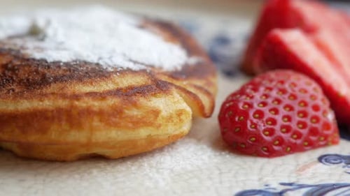 Tasty Meal with Berries and Pan Cake in Bowl on Black Background