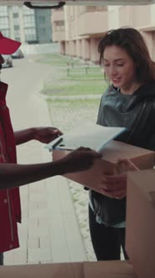 Delivery Man Giving Package to Customer, Signing Form