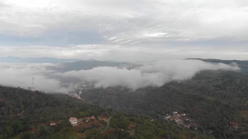 Drone view above rural road at cloudy morning