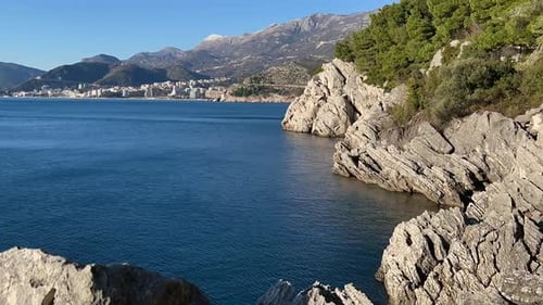 Timelapse Relief White Cliffs Surrounded By Dense Forest are Washed By the Mediterranean Sea
