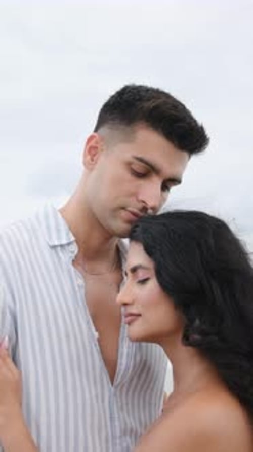 Romantic Couple Embraces by the Ocean