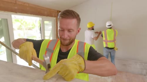 Construction Worker Accidentally Hits Finger During Home Renovation