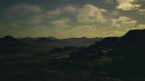 Remote Terrain with Weathered Rocks and Distant Plateaus Beneath Twilight