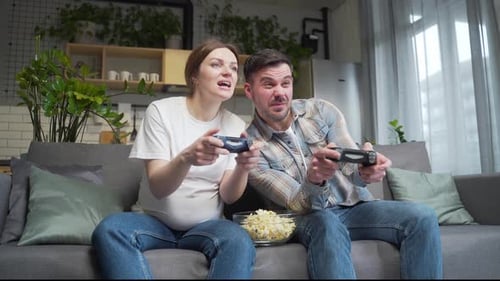 Happy Couple Playing Video Games Together at Home