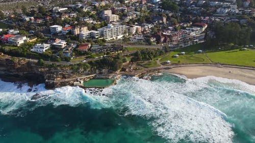 Scenery Of Ocean Waves Crashing At Bronte Baths And Sandy Shoreline At Sydney, Australia. aerial