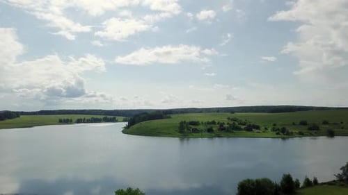 A Breathtaking Scenic Lake View Observed Beneath a Beautifully Cloudy Sky on a Tranquil Day Stock