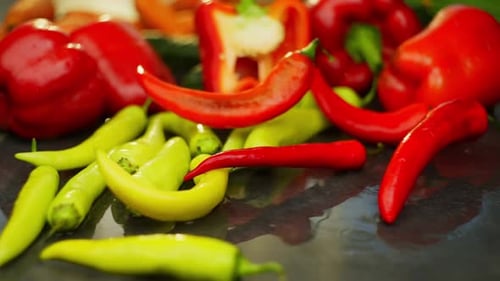 Juicy Spicy Red Pepper Falls on the Table Among Vegetables