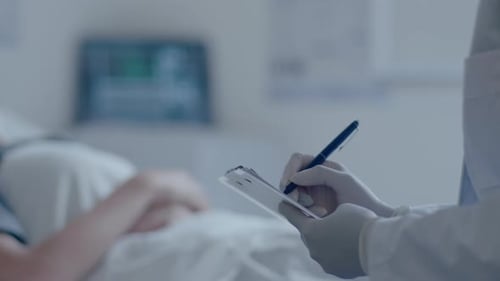 Female Patient in Mask Lying in Hospital Ward and Talking with Doctor