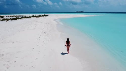 Woman Walks On Heavenly White Beach