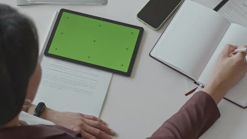 Woman Doing Paperwork and Using Digital Tablet with Green Screen