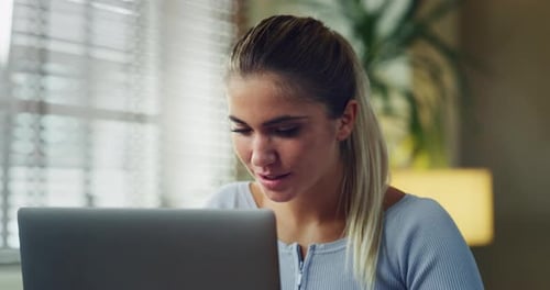 Woman Smiling at Laptop Screen Indoors