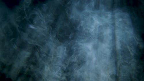 Slow Motion Abstract White Smoke Floating With Black Background Showing Light Beams