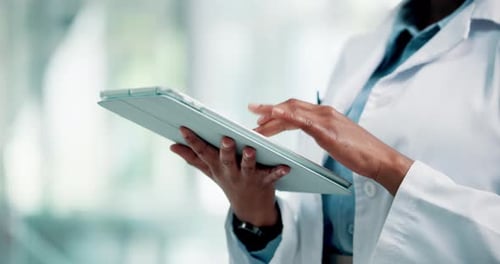 Hands, doctor and typing with tablet in hospital for medical history, patient report or records