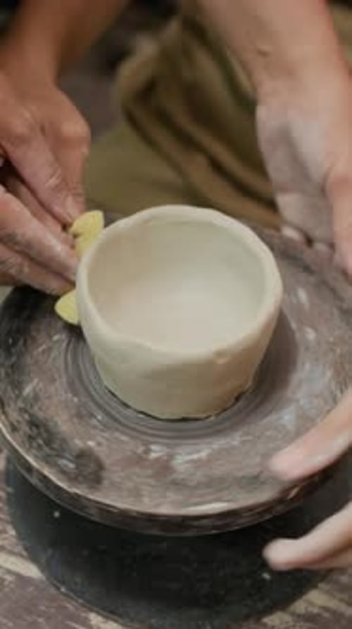 Hands Shaping Clay Bowl on Pottery Wheel