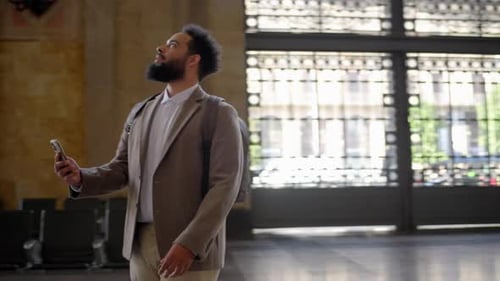 A Businessman Travels Through a Busy Train Station Showing His Urban Lifestyle and Ambition