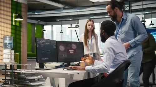 Programmer in Office Requesting Help From Coworkers to Fix Critical Error