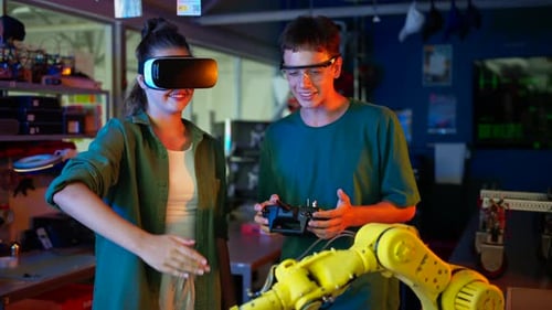 Young Engineers Controlling Robot Arm with VR Headset