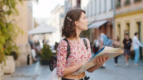 Woman Tourist Reading Map in City Street