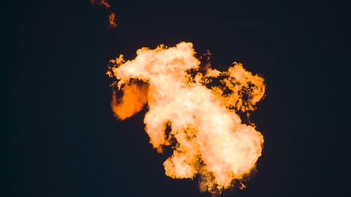Dramatic Close Up of Large Industrial Flame at Night