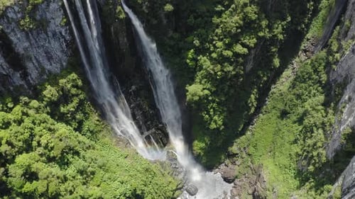 Breathtaking Aerial View of Twin Waterfalls Cascading Into Deep Canyon