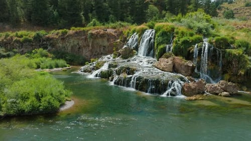 Waterfall Flowing Into Beautiful River Rising Aerial Drone View