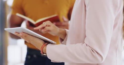 Colleagues Discussing Business on Tablet and in Notebook