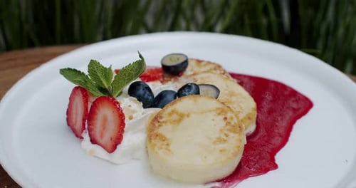 Delicious Pancakes with Fruit and Red Sauce