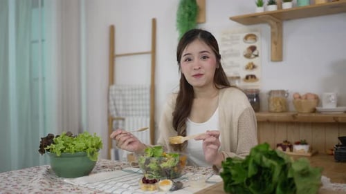 Woman Eating Salad in Sunny Kitchen