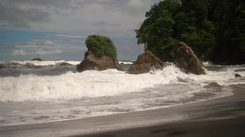 Waves Crashing on Rocky Tropical Beach Shore
