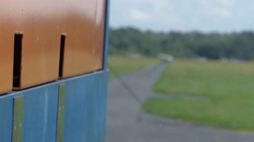 Winch for gliders stands on a way and in the distance there are gliders on the runway